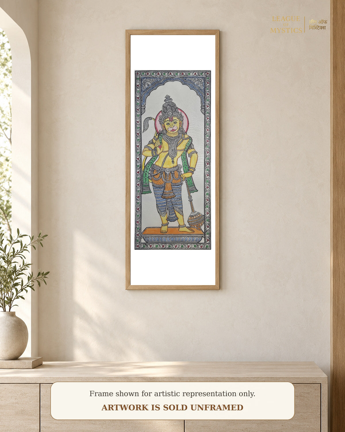 Hanuman Ji Pattachitra shown framed on a wall, marigold colourway