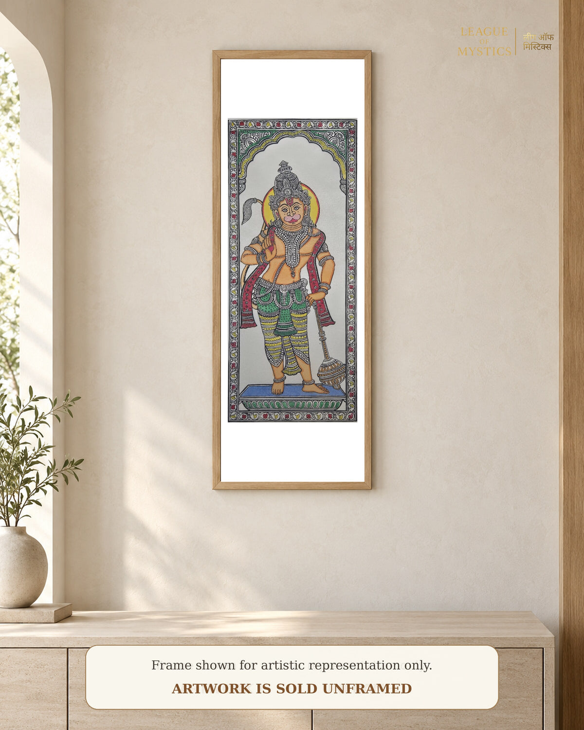 Hanuman Ji Pattachitra shown framed on a wall, terracotta colourway